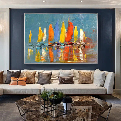Living room with a large abstract painting of sailboats on a blue background, a beige sofa with decorative pillows, and a coffee table.