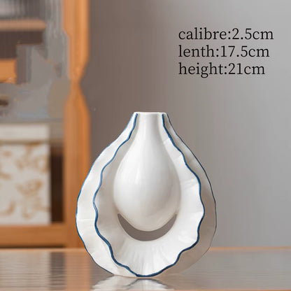 White ceramic vase with blue rim on a reflective surface, with measurements displayed.