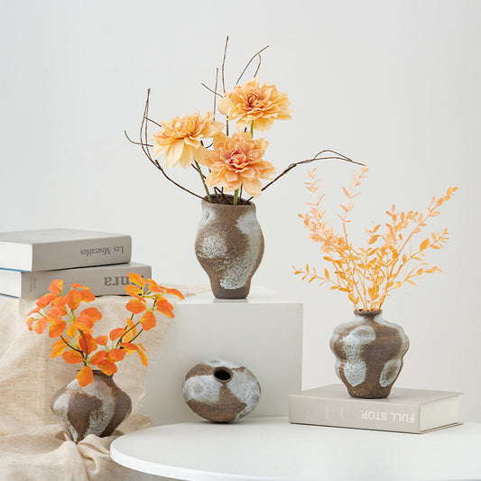 Decorative vases with flowers on a white surface