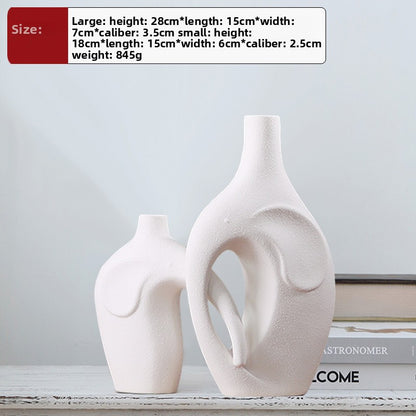 Two white ceramic vases on a shelf with size information displayed.