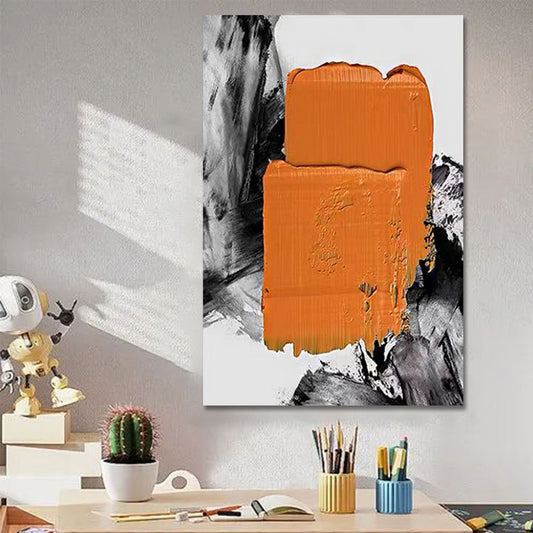 Abstract art piece with orange and black design on a wall above a desk.