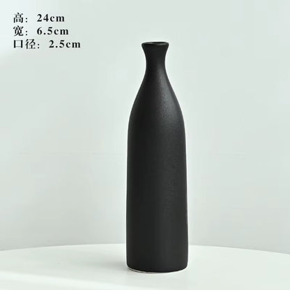 Black vase on a white background with dimensions displayed