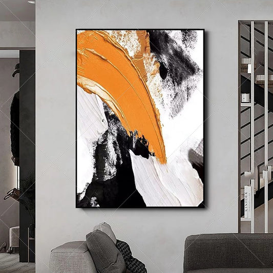 Abstract art piece with orange, black, and white colors on a wall in a modern interior setting.