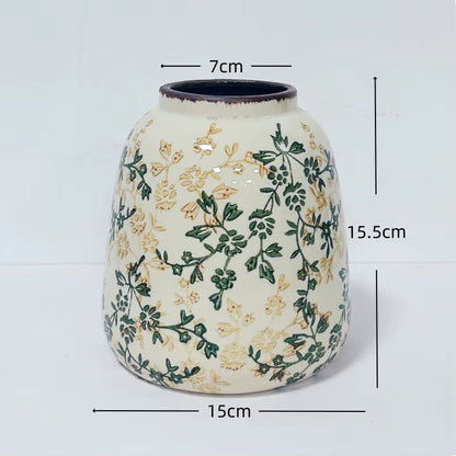 Ceramic vase with floral patterns and measurements on a white background