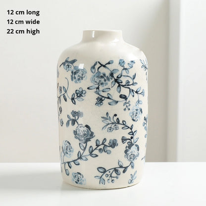 White vase with blue floral pattern on a white background