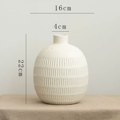 White textured vase with measurements on a neutral background