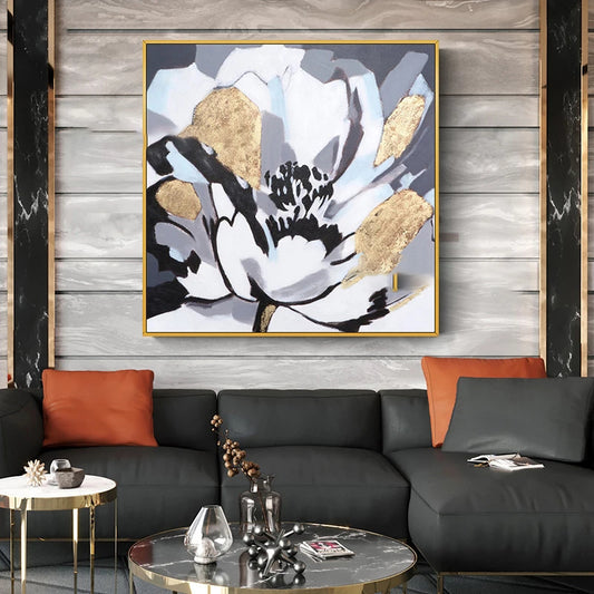 Modern living room with a black and gold abstract painting on a wooden wall.