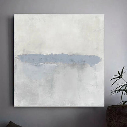 Abstract painting with a blue accent on a gray wall