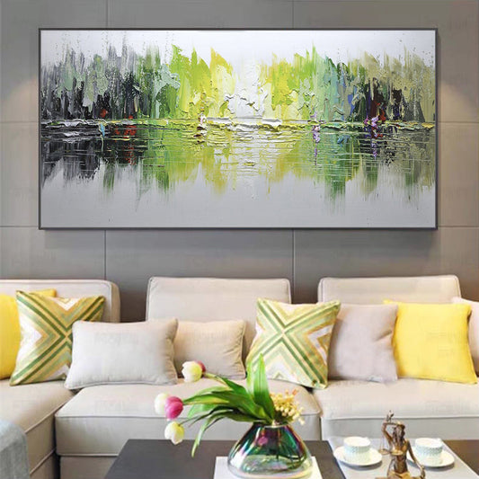 Abstract painting on a wall above a beige sofa with colorful cushions in a living room setting.