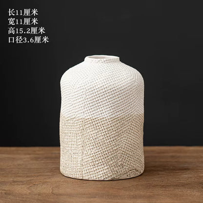 Textured ceramic vase on a wooden surface with a dark background
