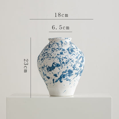 Blue and white ceramic vase with dimensions on a light gray background