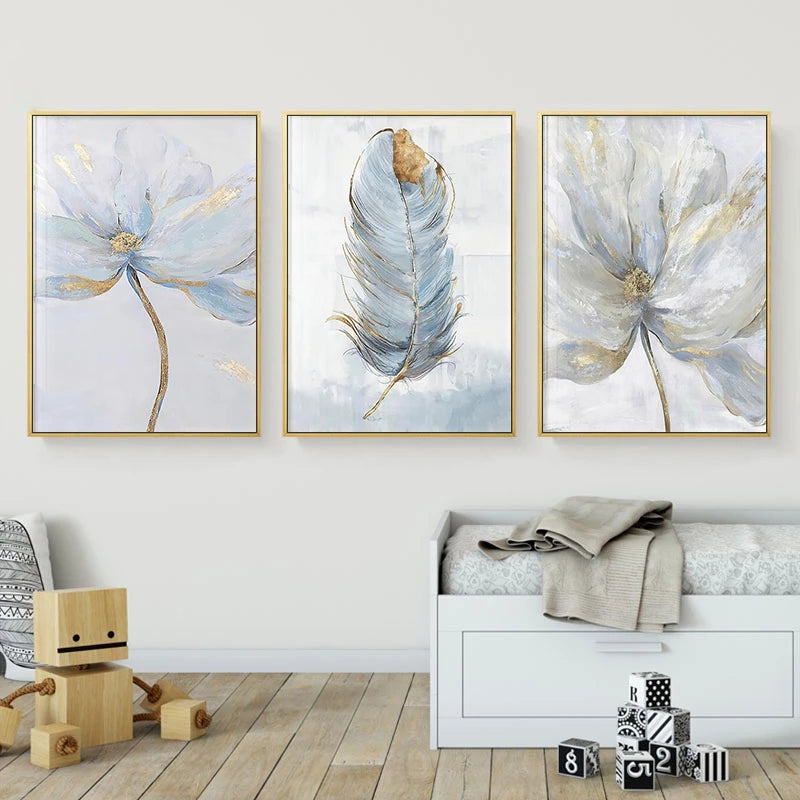 Three abstract wall art pieces in gold frames on a white wall above a bed.