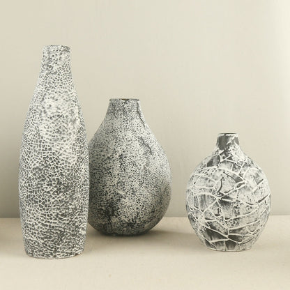 Three textured vases of different sizes on a neutral background