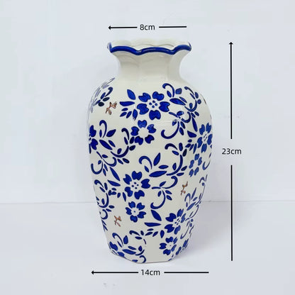 White vase with blue floral patterns and measurements on a white background