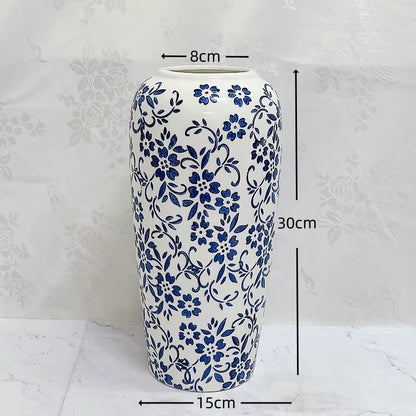 Ceramic vase with blue floral patterns and measurements on a white background