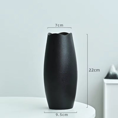 Black vase with measurements on a light gray background