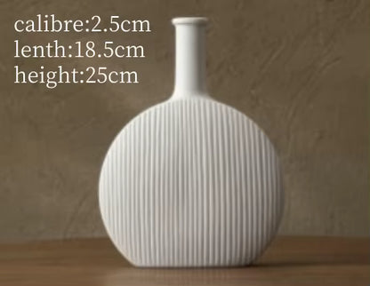 White ribbed vase on a wooden surface with measurements displayed.