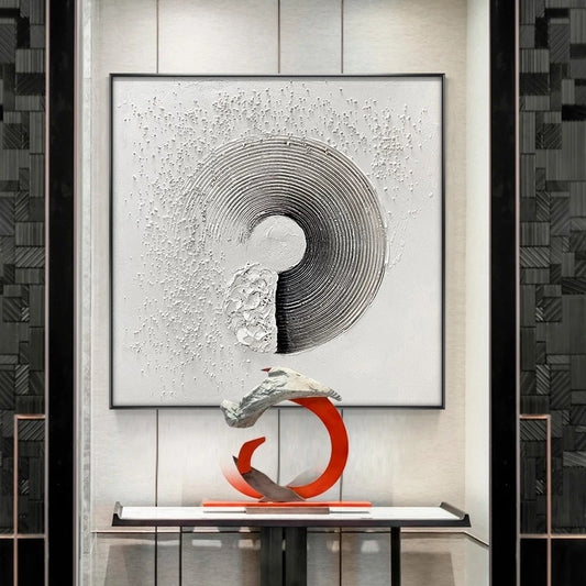 Abstract sculpture on a table with a modern wall art piece in the background