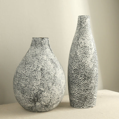 Two textured vases on a neutral background