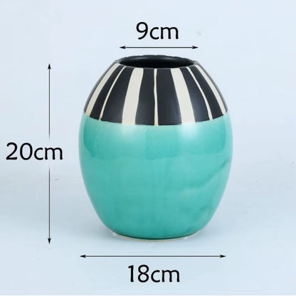 Turquoise vase with black and white striped top, measurements indicated on a light blue background