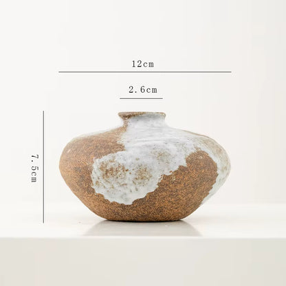 Ceramic vase with measurements on a white background