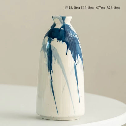 Ceramic vase with blue and white abstract design on a beige background