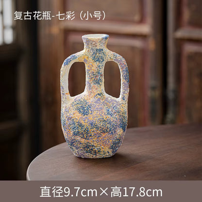 Decorative ceramic vase with speckled design on a wooden surface