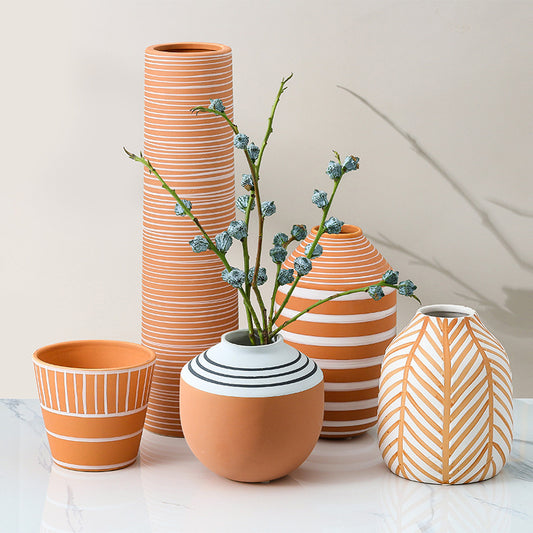 Set of ceramic vases with striped and patterned designs on a light background