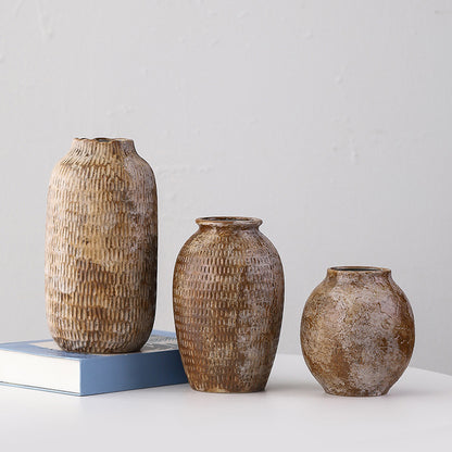 Three textured ceramic vases of different sizes on a light gray background