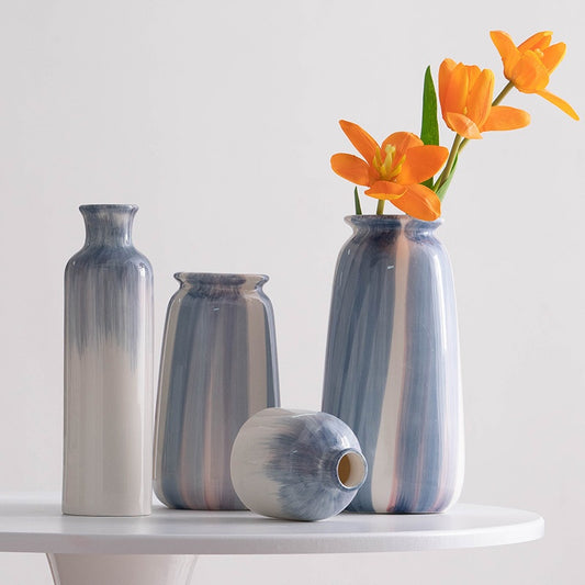 Set of ceramic vases with striped design on a white surface