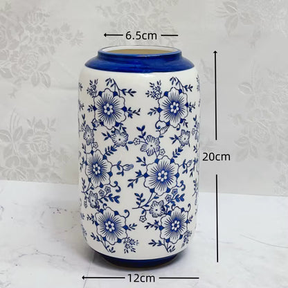 Ceramic vase with blue floral patterns and measurements on a white background