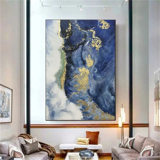Abstract art piece with blue and gold tones in a living room setting.