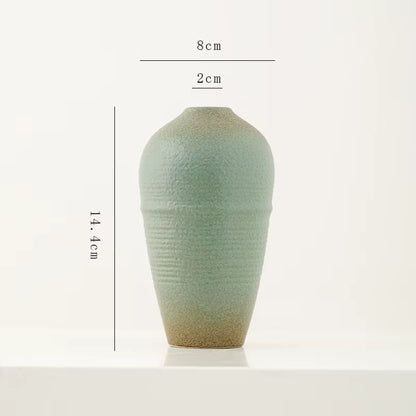 Green ceramic vase with dimensions on a white background