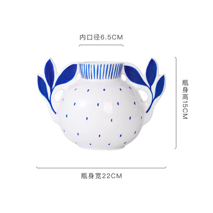 White ceramic jar with blue floral handles and patterns, shown with dimensions on a white background.