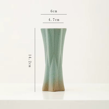 Green ceramic vase with dimensions on a white background