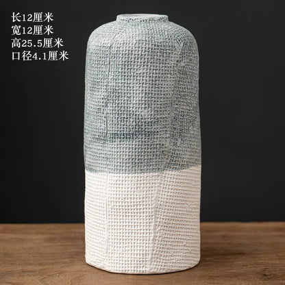 Decorative vase with textured design on a wooden surface and black background