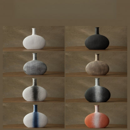 Collection of variously colored textured vases on a wooden shelf against a brown background