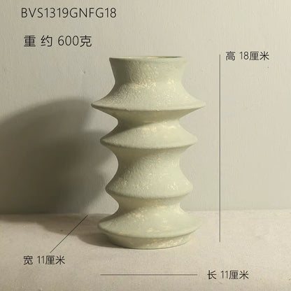 Green ceramic vase with measurements on a light gray background
