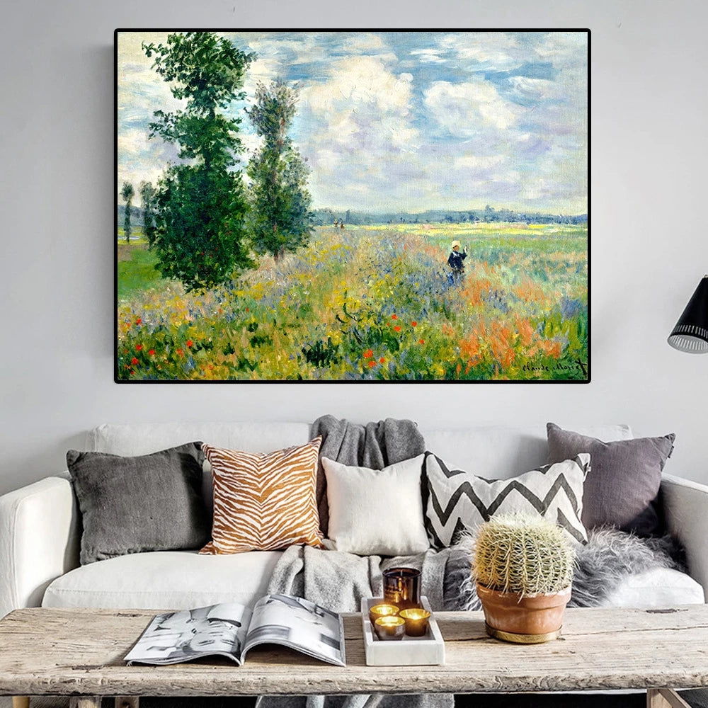 Framed painting of a landscape with a field and trees above a living room sofa.