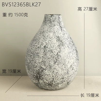 Speckled vase on a beige background with measurements indicated