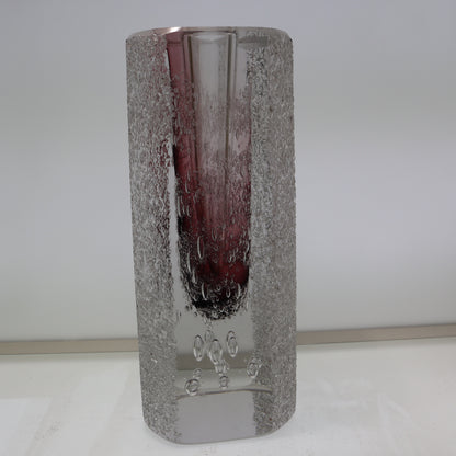 Decorative glass vase with textured silver base and purple interior on a white background