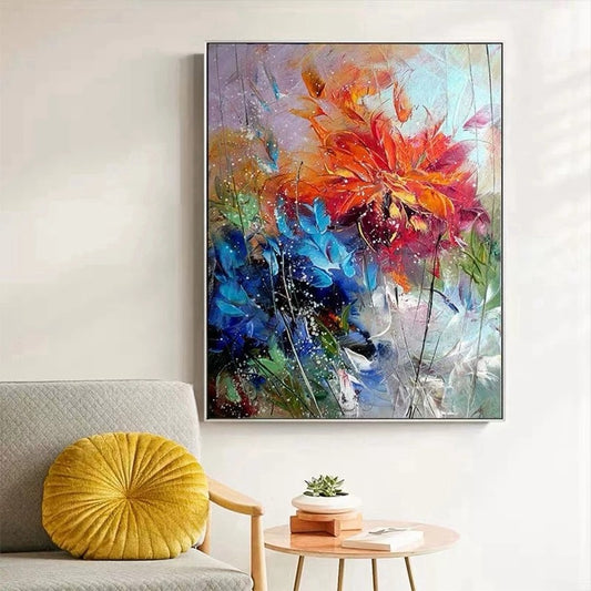 Colorful abstract floral painting on a wall above a sofa with a yellow pillow.