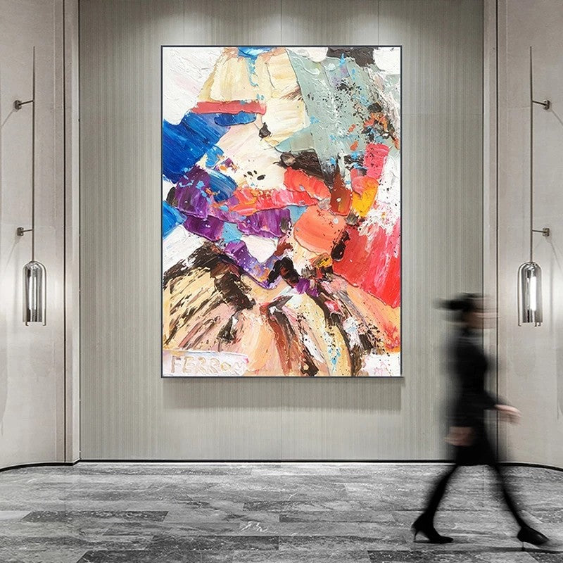 Abstract colorful painting on a wall with a person walking by.