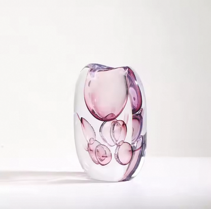 Glass vase with pink and clear design on a white background