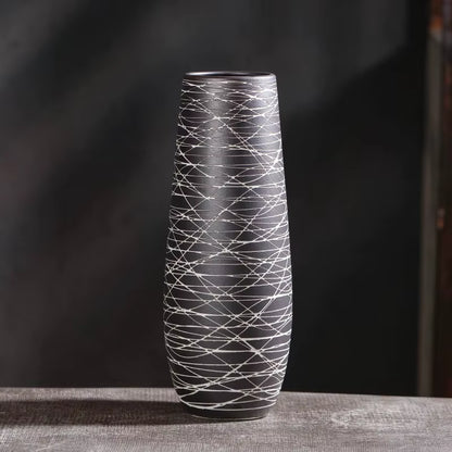 Black and white patterned vase on a dark background