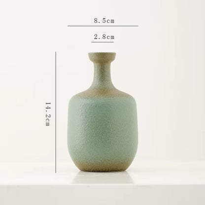 Green ceramic vase with dimensions on a white background