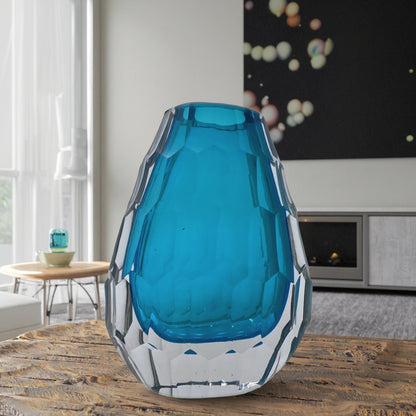 Blue glass vase on a wooden table in a living room setting