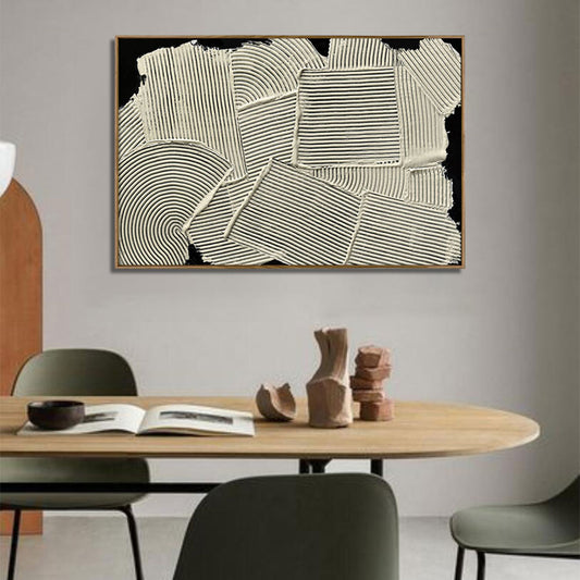 Abstract art piece on a wall above a dining table with decor items.