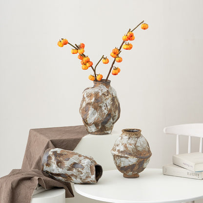 Decorative vases with floral arrangement on a white surface