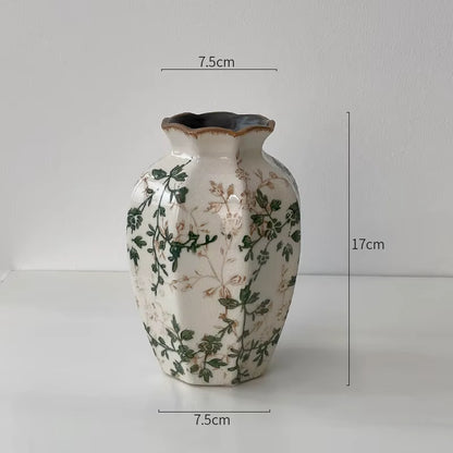 Decorative vase with floral patterns and measurements on a plain background